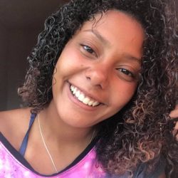 Smiling young woman with purple t-shirt in rio de janeiro