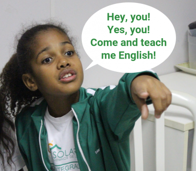 Volunteering advert with EduMais student pointing and calling for volunteers to teach English in Brazil