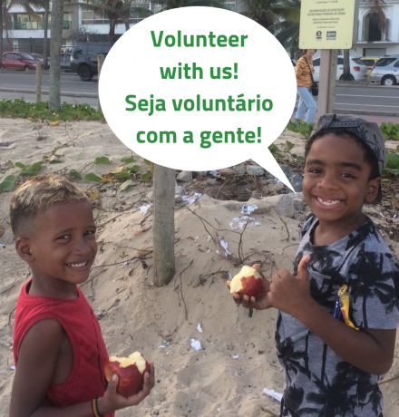 Two boys on EduMais's after-school program on the beach with a speech bubble calling for volunteers to join them