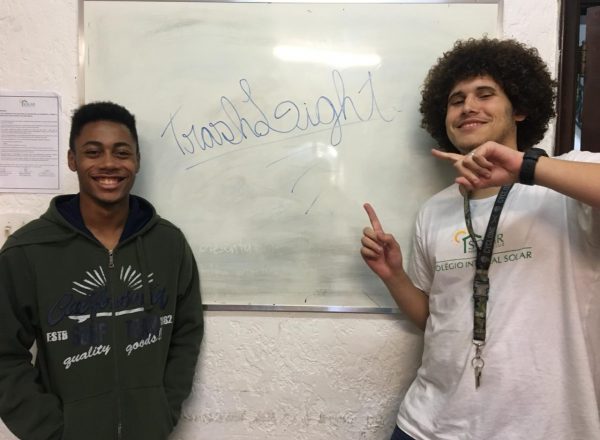 Two of EduMais's Entrepreneurship and Enter the Labour Market courses point to their company name, TrashLight, on the classroom's whiteboard