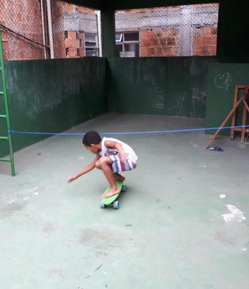 One of EduMais's after-school students plays a game of skateboard limbo