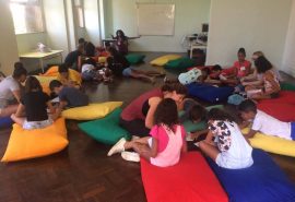 Layout of English Summer Camp learning space with students, volunteers and big colourful cushions