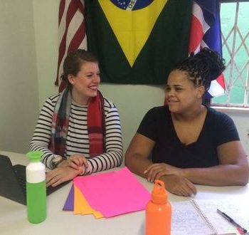 EduMais office support volunteers Iris and Adrienne working together