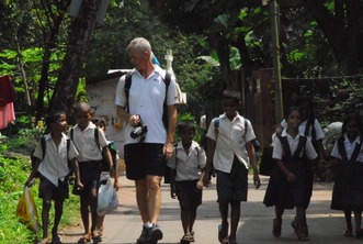 EduMais founder Diana Nijboer's husband Gerard walking with a group of children