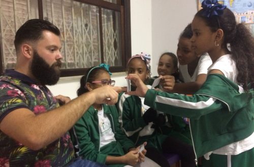 Some of EduMais's students surround Daan, who volunteered to teach English in Brazil with EduMais