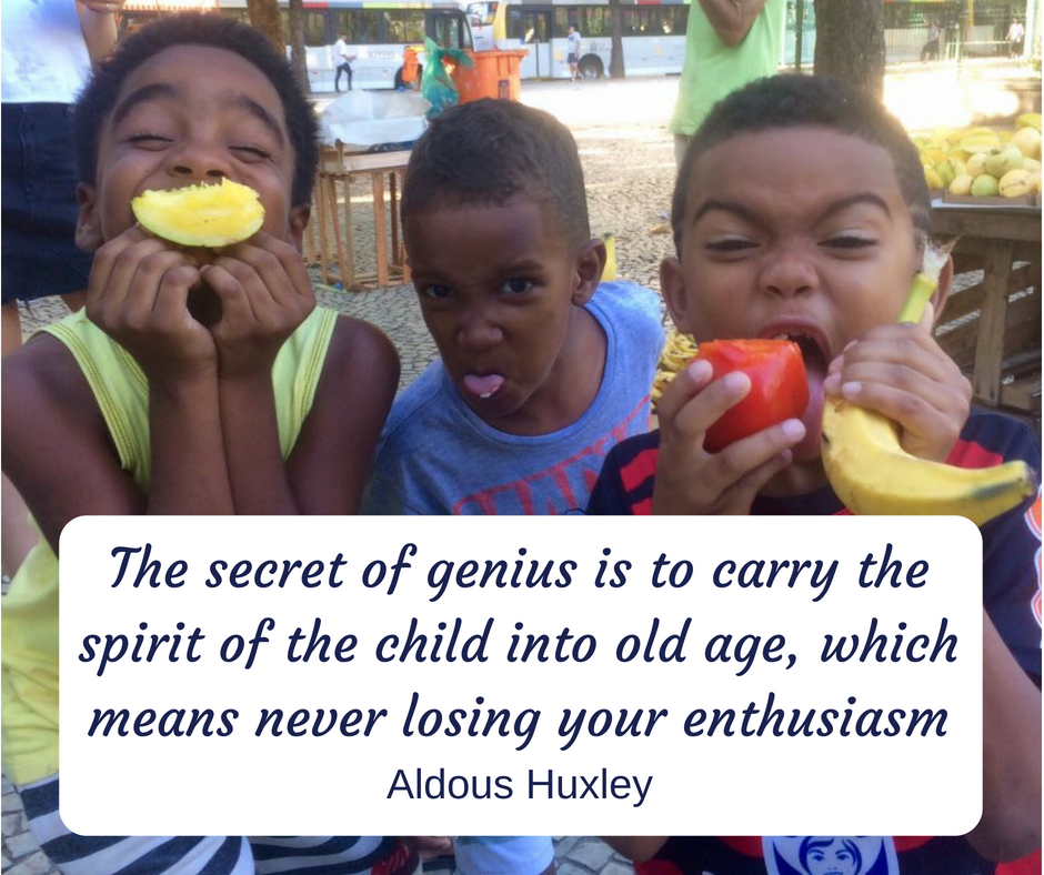 Boys on After-School Program pose with various fruits with Aldous Huxley quote about the spirit of the child overlaid on image